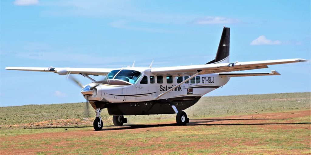 Safari link plane landing at Mara Keekorok Airstrip Kenya