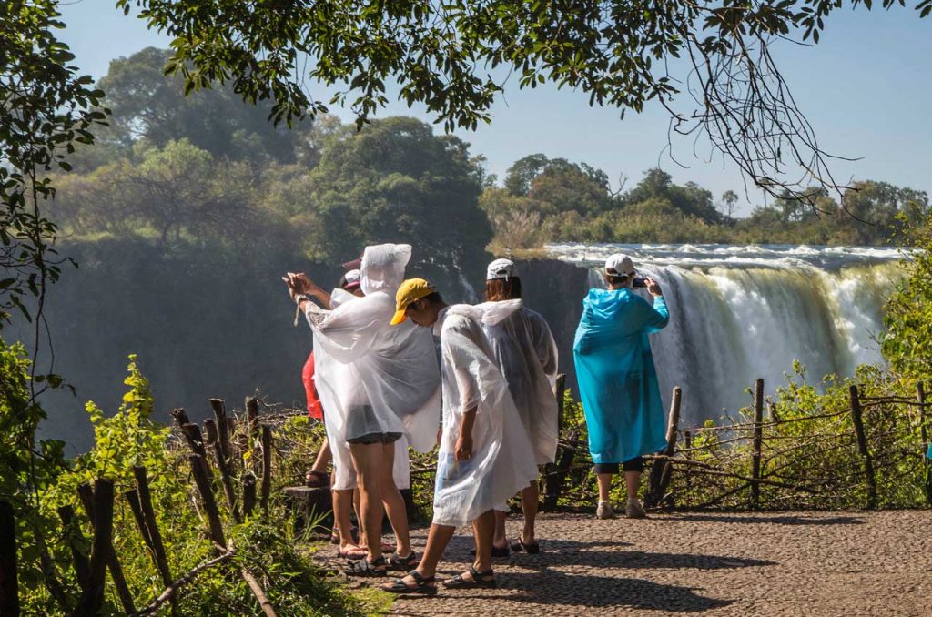 Tourists at a view point viewing Victoria falls during the victoria falls tour Zimbabwe.