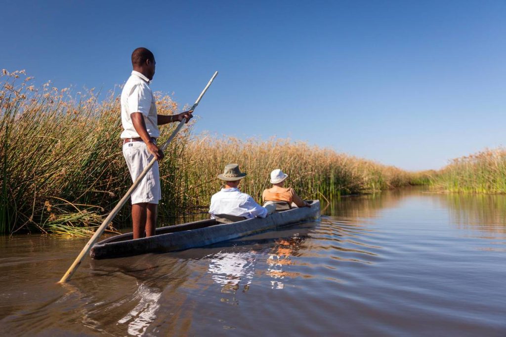 Tourist-sitting-in-amokoro-caneo-in-search-fo-animals-at-Okavango-delta-botswana