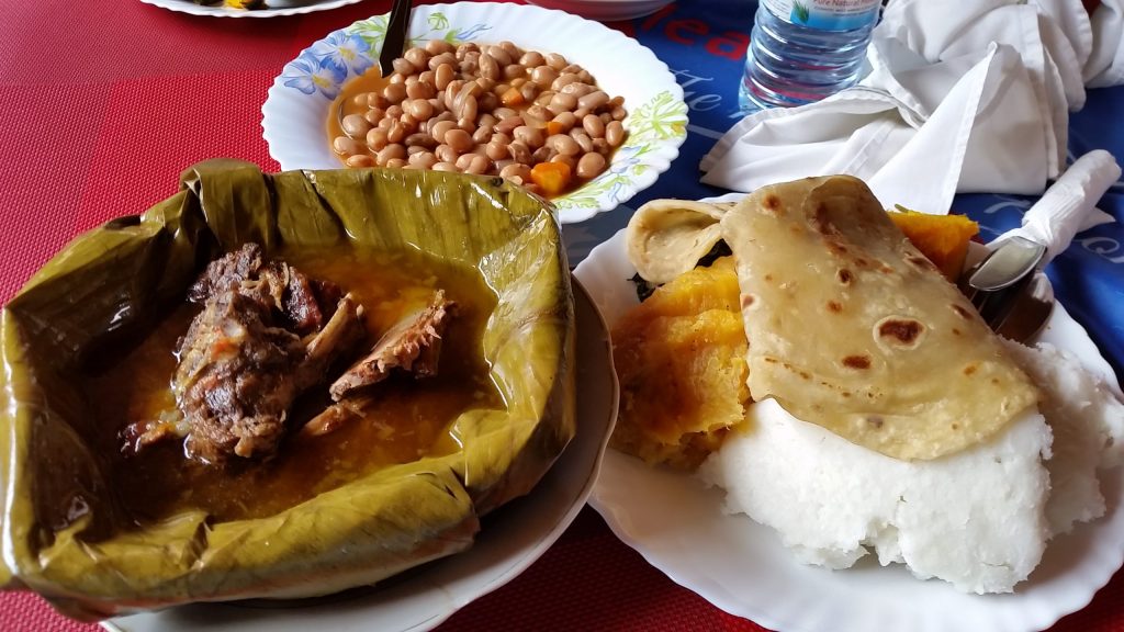 Ugandan local dish steamed chicken, fresh local beans chapati, green bananas(matoke) and maize past( Posho). 