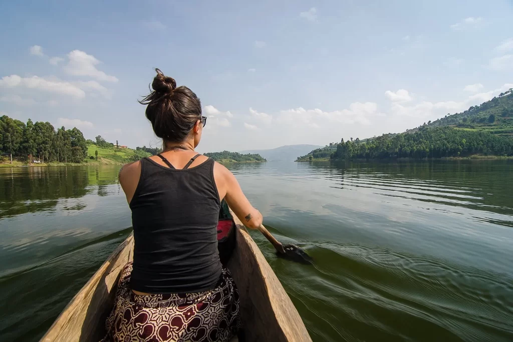 A tourist paddling a canoe on Lake bunyonyi Uganda