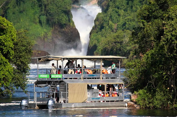 Victoria bocruise at the view of the bottom of The mighty water fall in Murchison Falls National Park Uganda Africa