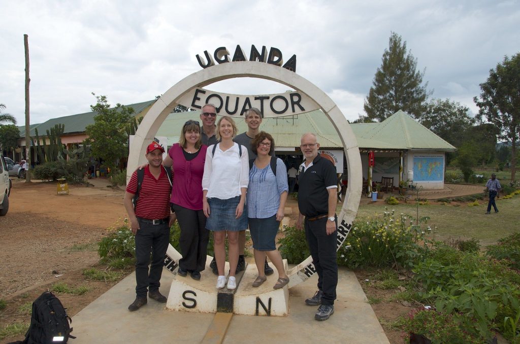 A group of tourists posing for a photo at the equator Kayabwe Uganda Africa 