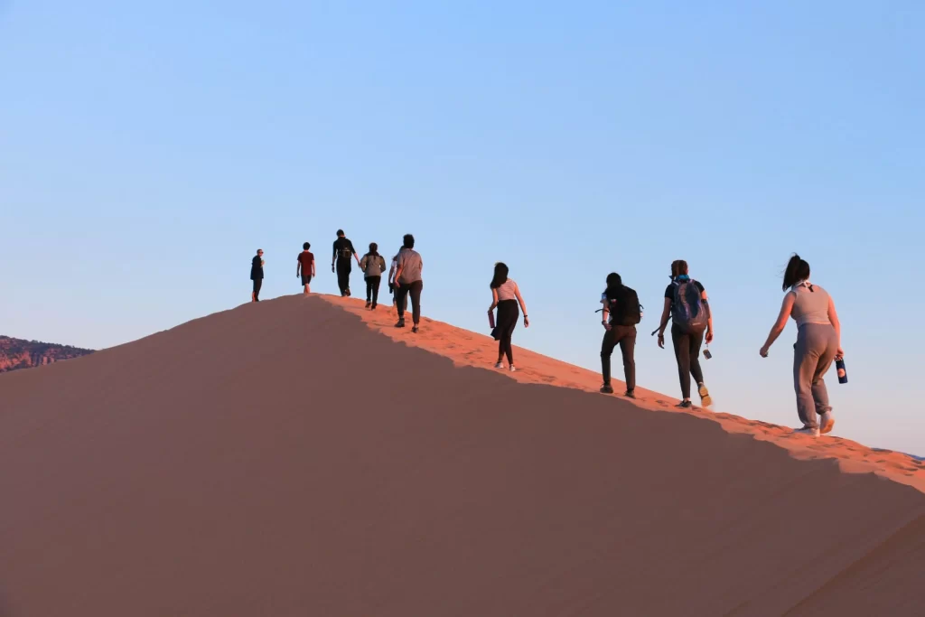 Tourists hiking one of the highest sand dune at Sunset over the highest sand dunes in Namibia.