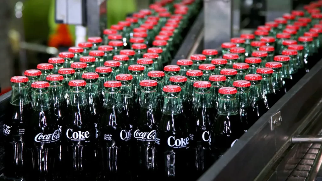 Soda bottles moving to the packing zone coca cola factory Uganda.