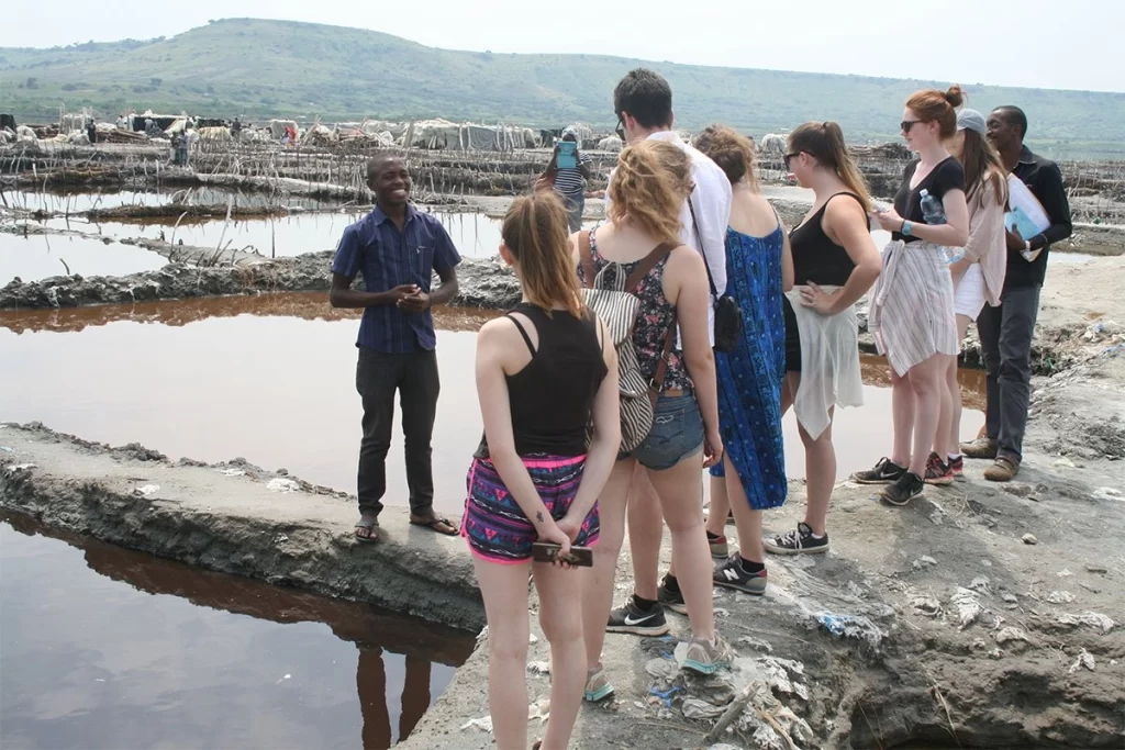 Students listening to the salt miner Lake Katwe Uganda.