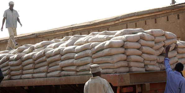 Workers loading cement on the track for distribution Tororo Uganda