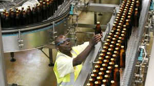 Beer Factory Employee sorting beer bottles at Nile Breweries Factory Jinja Uganda