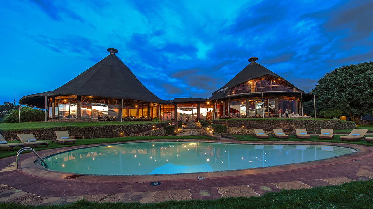 Ngorongoro sopa lodge swimming pool with restaurant and bar in background