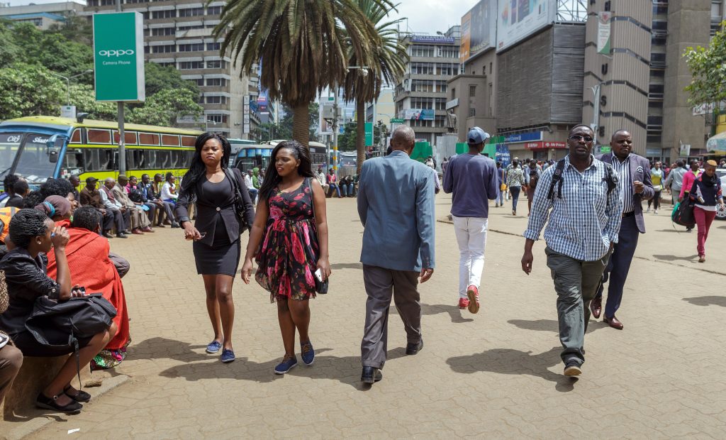 People walking along the busy city street Nairobi Kenya.
