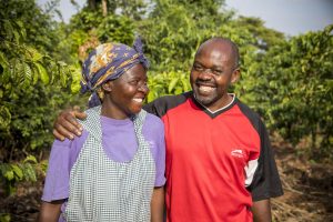 A smiling couple in their coffee plantation Uganda Africa.