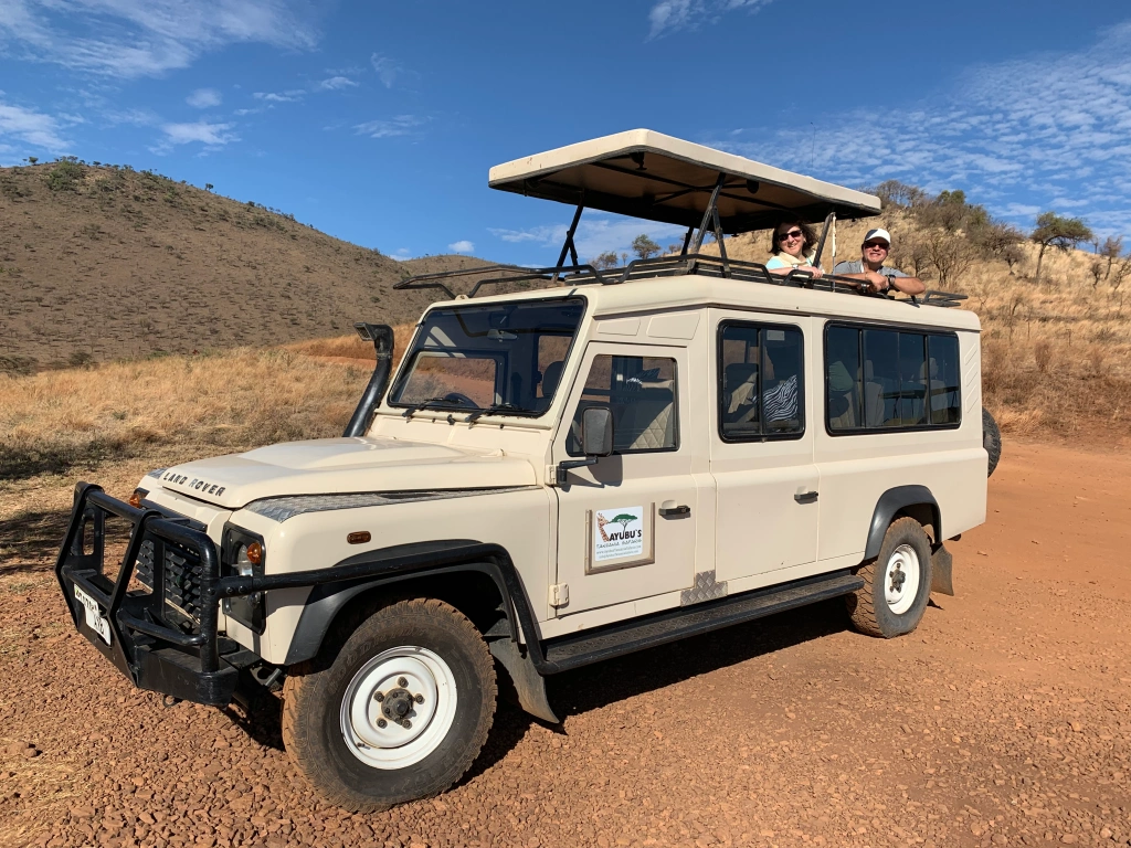 Game viewing safari pop up-top roof land Rover