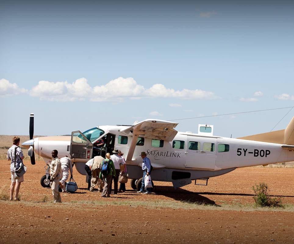 Tourist boarding a light air craft to transfer them to the next national park