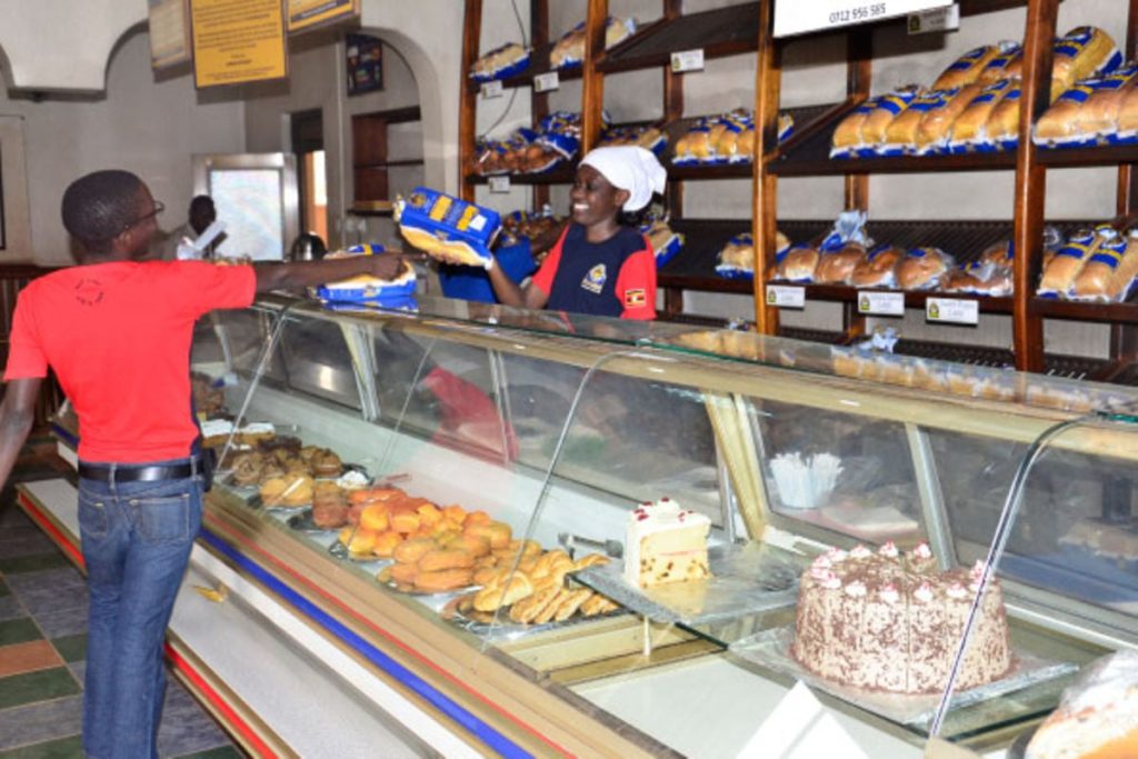 Customer purchasing hotloaf products hot loaf shop Kampala Uganda.