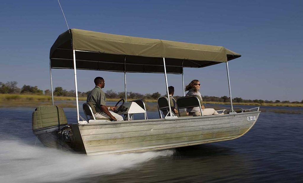 Motor boat cruising along Okavango delta river Botswana