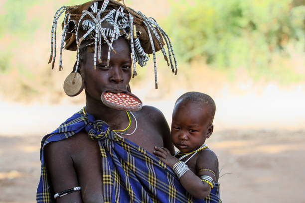  Omo valley Mursi village lady and her child Ethiopia