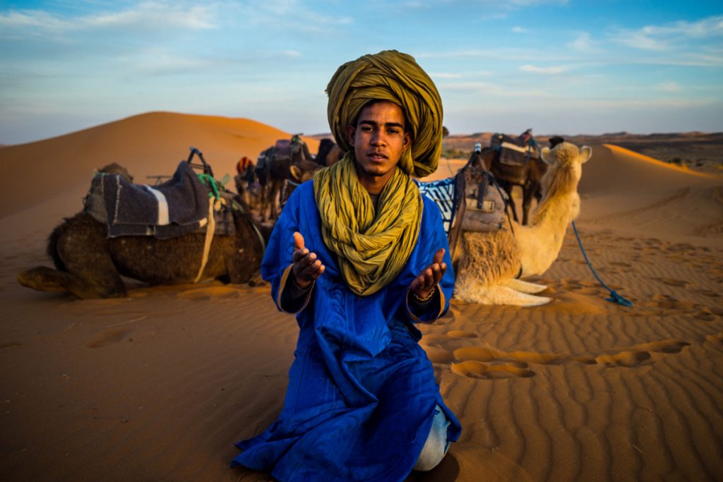 A Berber praying at sunset Marrakesh Morocco